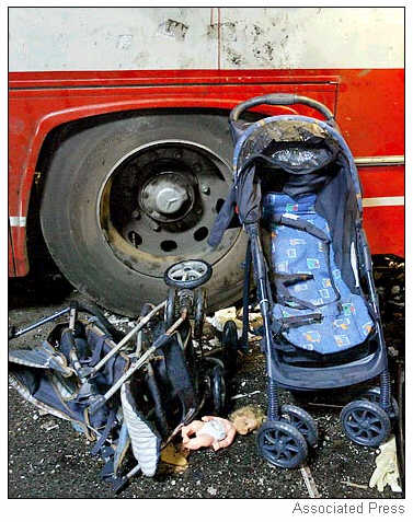 A baby doll and two strollers lay strewn at the site of the explosion.