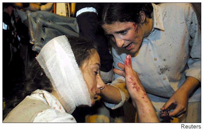 An Israeli woman receives first aid after being injured in the explosion.