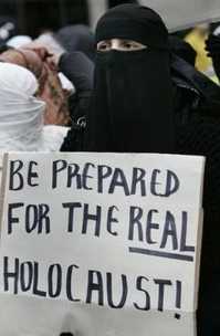 Muslim demonstrator with sign: 'BE PREPARED FOR THE REAL HOLOCAUST!'