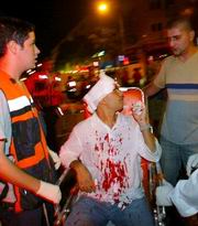 Rescue workers evacuating a man wounded in the suicide bombing in Jerusalem on Tuesday night.
