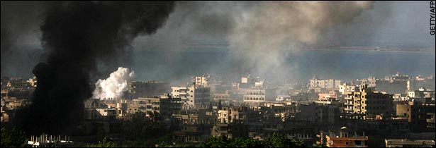 Heavy shelling leaves a dark plume of smoke over the Palestinian refugee camp.  (Daily Telegraph)