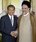Malaysian PM Mahathir Mohamad (L) greeting Iran's Mohammad Khatami at the OIC summit in Putrajaya on Thursday.